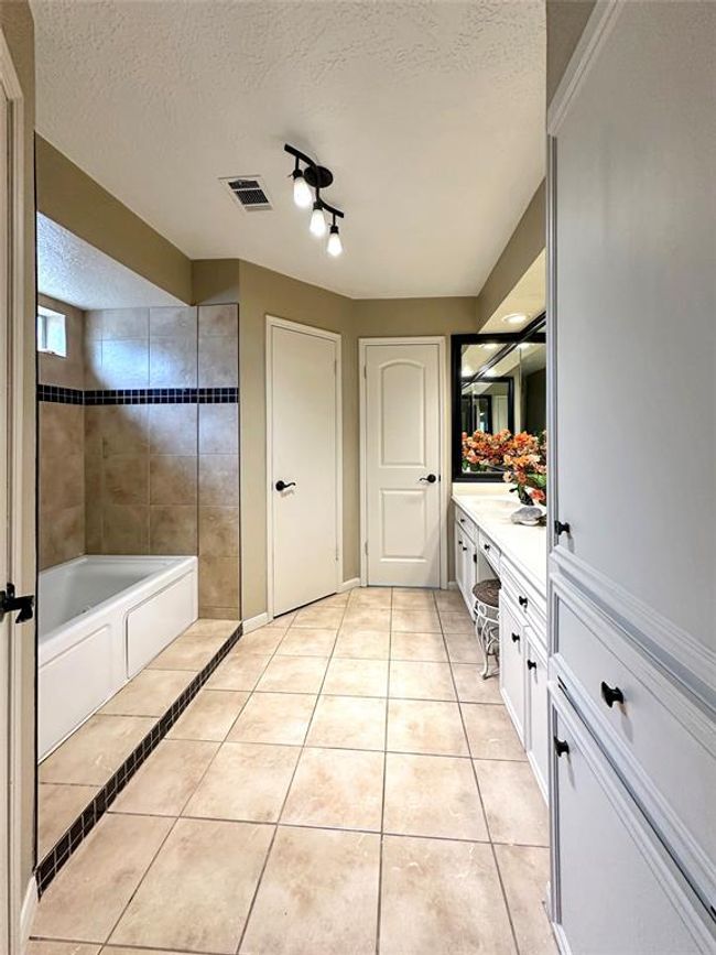 Primary restroom features dual walk-in closets and an ensuite bath. | Image 17