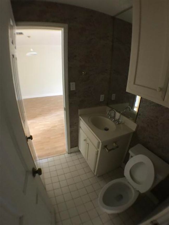 Bathroom with tile patterned floors, vanity, and toilet | Image 8