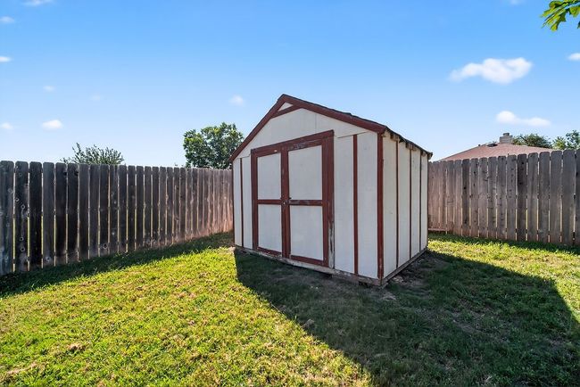 View of shed featuring a fenced backyard | Image 34