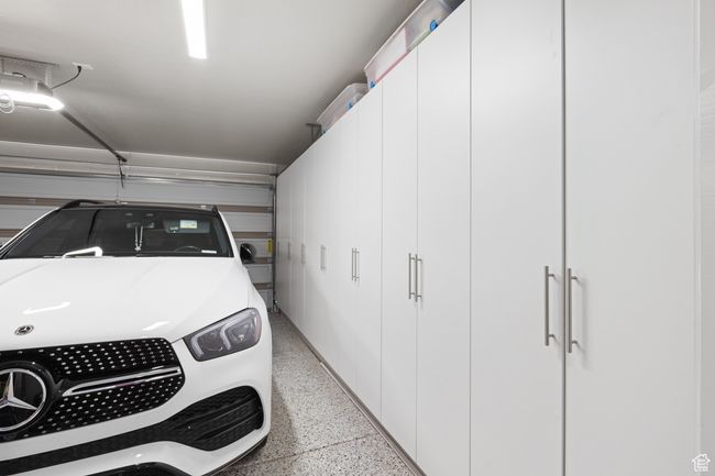 Garage with washer / clothes dryer and a garage door opener | Image 42