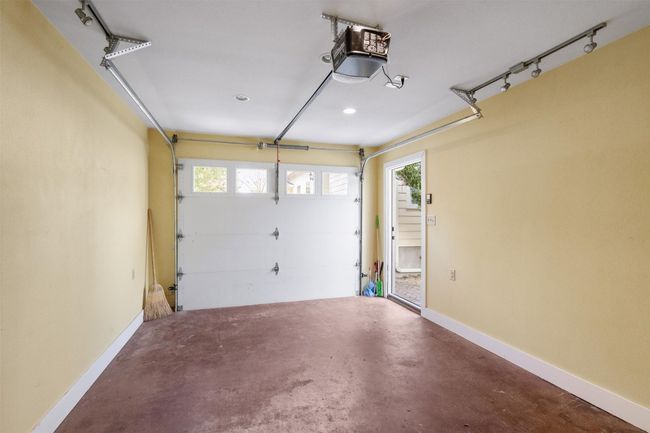 Garage featuring baseboards and a garage door opener | Image 27