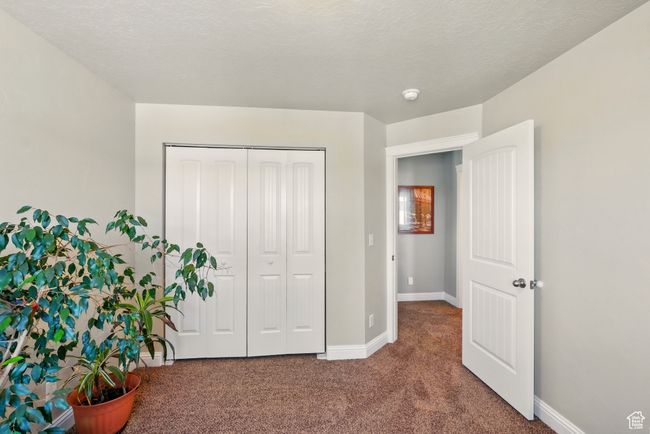 Carpeted bedroom featuring baseboards and a closet | Image 21