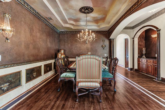 No attention to detail was spared in this home, from the ornate crown molding, picture frame molding, chair rail and wall sconces, and the built-in butler's pantry nearby! | Image 10