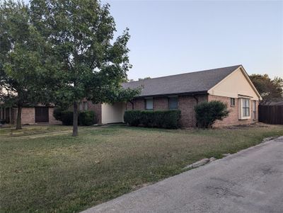 Side view of property exterior with a lawn | Image 2