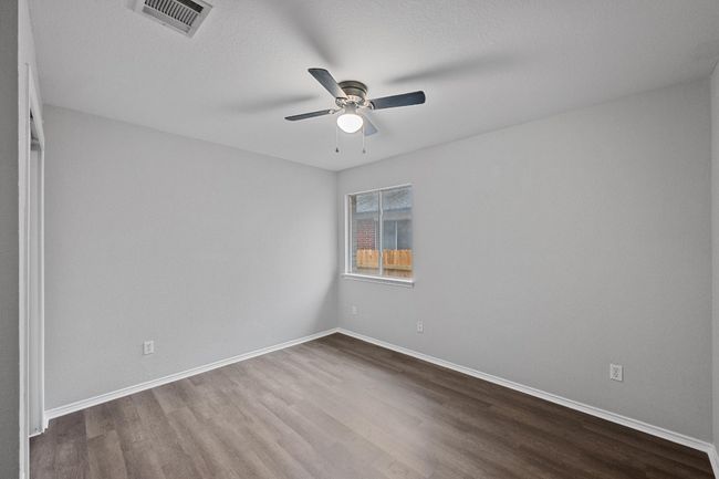 Bedroom with new floors and ceiling fan | Image 17