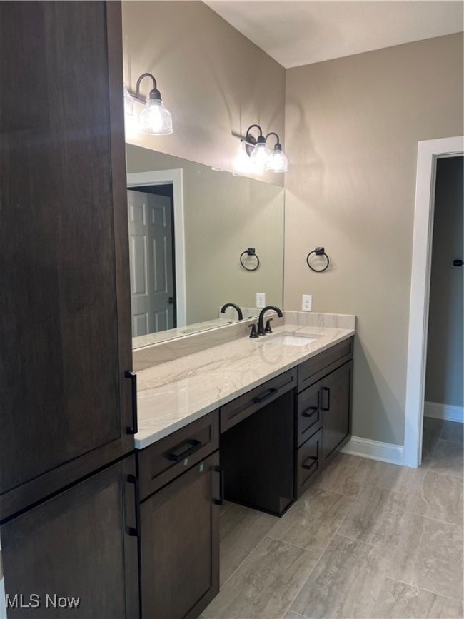 Bathroom featuring vanity and baseboards | Image 9