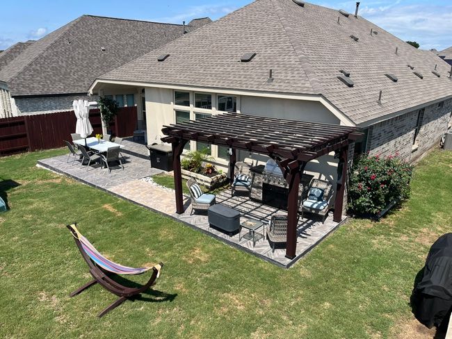 Back of property featuring a pergola, a patio area, outdoor lounge area, and roof with shingles | Image 4