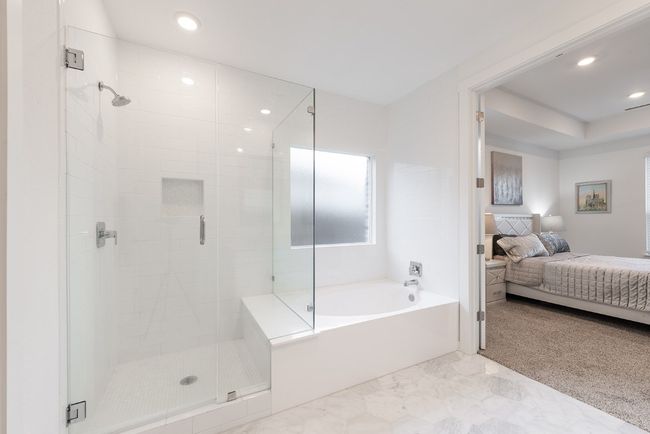 Bathroom featuring recessed lighting, connected bathroom, a stall shower, and a bath | Image 5