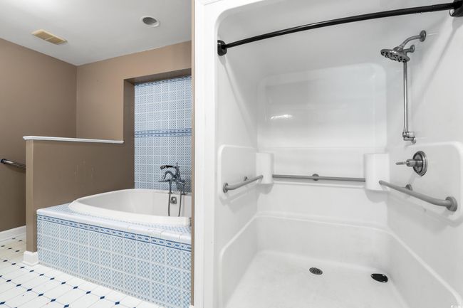 Bathroom with a garden tub, a shower, and tile patterned floors | Image 15