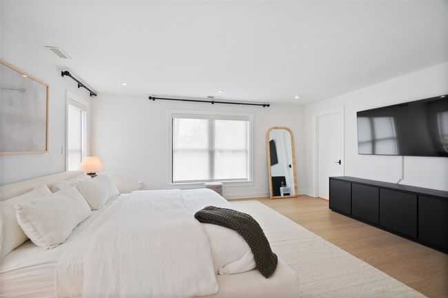 Bedroom featuring recessed lighting, light wood-style floors, and multiple windows | Image 18
