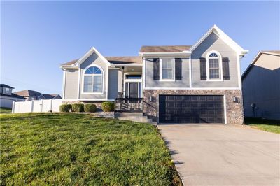 View of front of property featuring a front lawn and a garage | Image 2