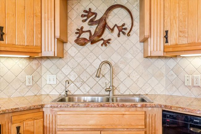 Kitchen featuring a sink, light countertops, tasteful backsplash, and dishwasher | Image 17