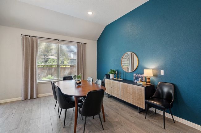 Dining area featuring lofted ceiling, light wood finished floors, and recessed lighting | Image 13