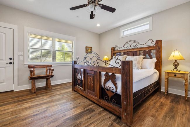 Bedroom featuring wood finished floors, baseboards, a ceiling fan, and recessed lighting | Image 34