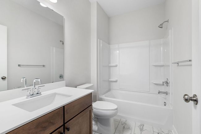 This stylish main level full bathroom features modern fixtures and elegant finishes, offering both convenience and charm. | Image 30