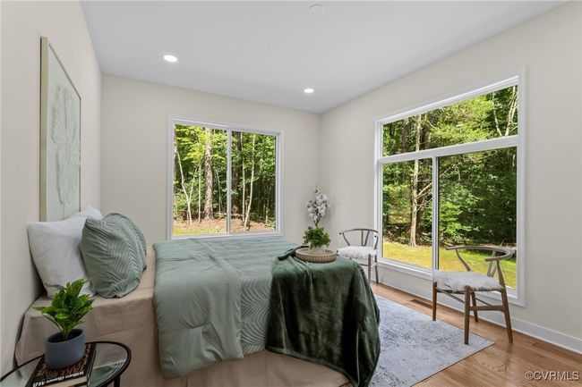 Bedroom with wood finished floors and recessed lighting | Image 19