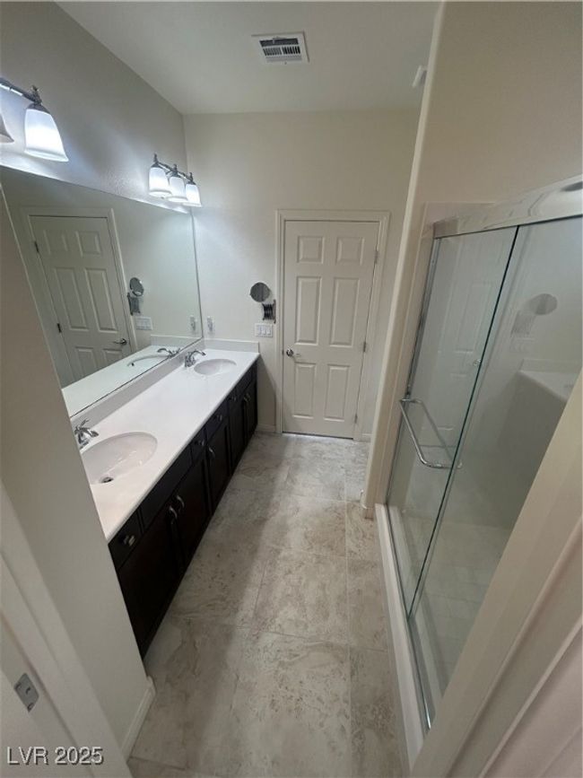 Full bathroom with double vanity and a stall shower | Image 10