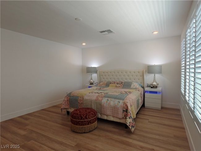 Bedroom featuring baseboards, light wood-type flooring, visible vents, and recessed lighting | Image 33