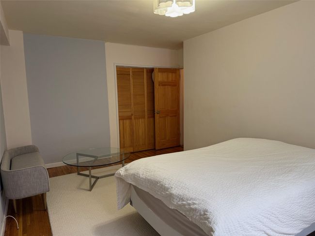 Bedroom featuring a closet and wood finished floors | Image 8