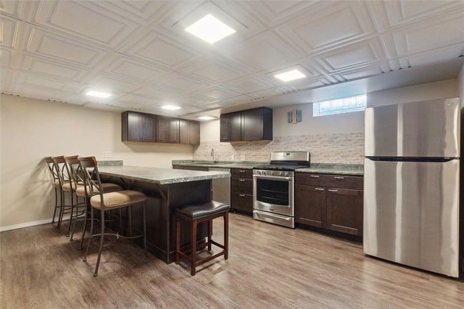 basement kitchen with gas range | Image 25
