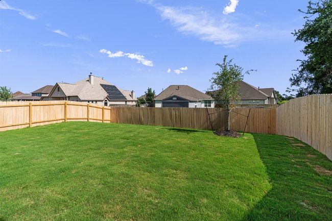Fenced backyard with a residential view | Image 25