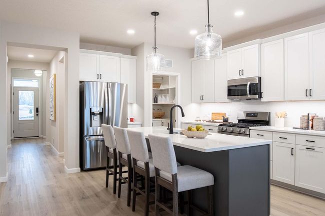 This thoughtful layout ensures everything is within reach, while beautiful cabinetry and modern finishes create a warm, inviting atmosphere. Photos are from a previously built home; options and features will vary. | Image 6