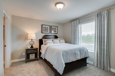 The center of the home, the kitchen! Featuring a large island, quartz countertops, subway tile backsplash, gas cooktop, microwave that vents to exterior, double ovens, and huge walk-in pantry! | Image 2