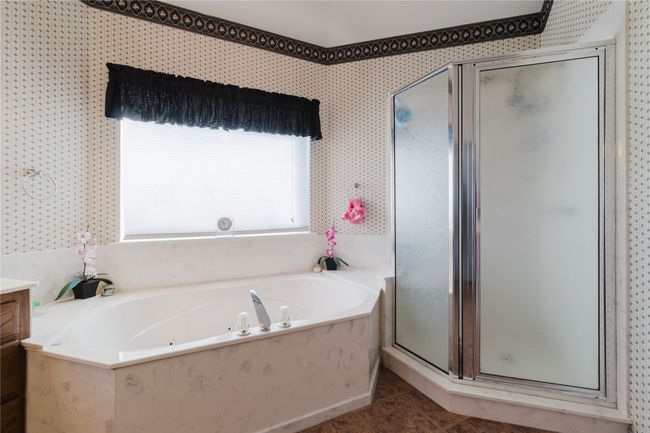 Bathroom with vanity, tile patterned flooring, and shower with separate bathtub | Image 24