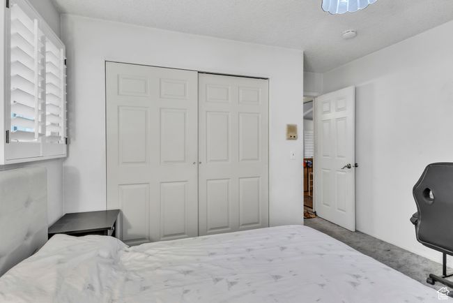 Bedroom featuring carpet flooring and a closet | Image 14