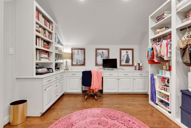 Upstairs, the hobby room above the primary closet is thoughtfully finished with a built-in desk workspace, custom shelving, and wraparound cabinetry, making it ideal for crafting, reading, or quiet productivity. | Image 28