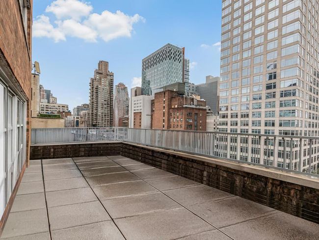 View of patio with a view of city | Image 9