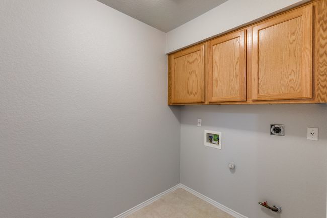 Laundry room with gas dryer hookup, hookup for a washing machine, electric dryer hookup, and cabinet space | Image 34