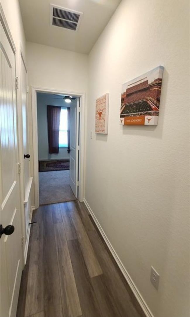 Hall with dark wood-type flooring and baseboards | Image 5