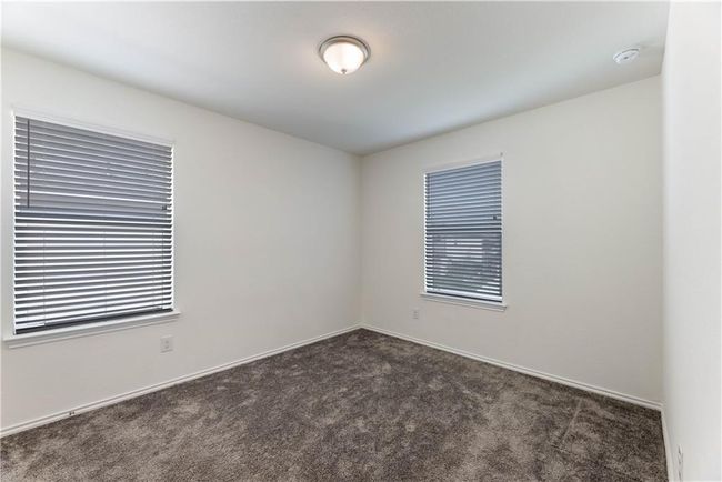 Unfurnished room with dark carpet and a smoke detector | Image 27