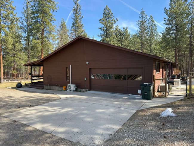 View of side of home featuring driveway and attached garage | Image 48