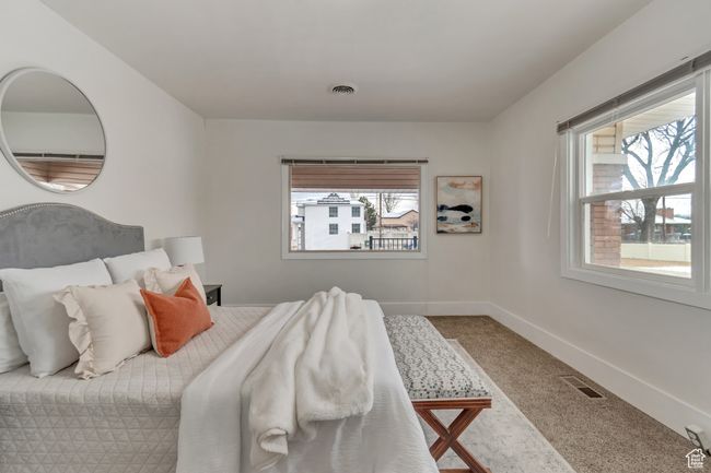 Bedroom featuring visible vents, baseboards, and carpet floors | Image 8