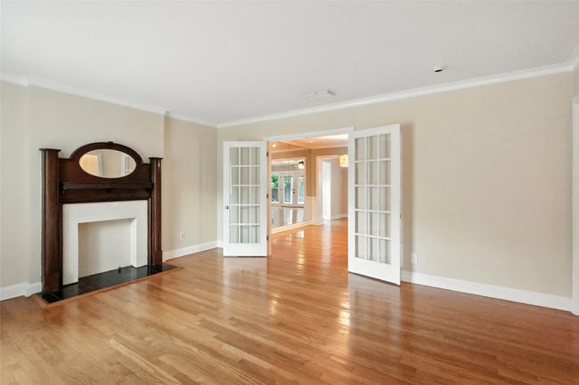 Dining room featuring plenty of natural light, french doors, light wood-type flooring, and crown molding | Image 9