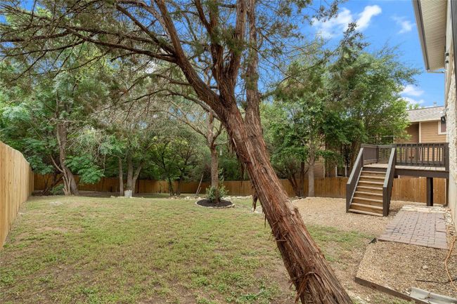 View of yard with a deck, stairway, and a fenced backyard | Image 34