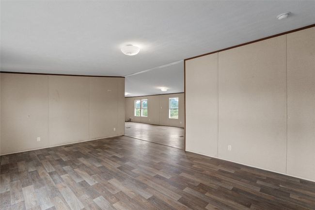 Unfurnished room with vinyl finished floors and a smoke detector | Image 8