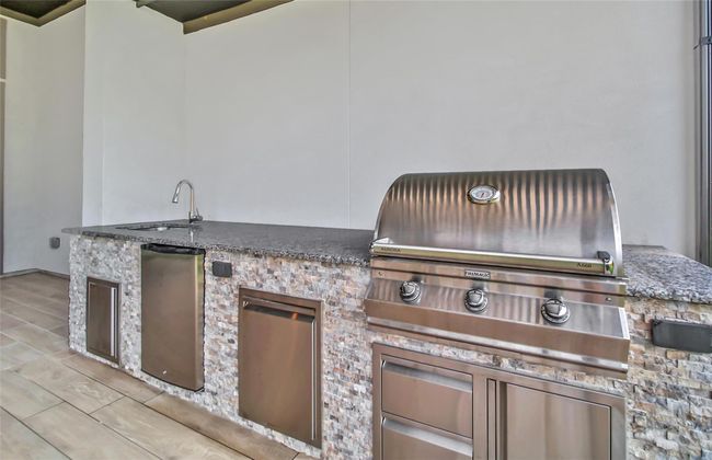 Spacious covered patio featuring a built-in grill, perfect for outdoor cooking and entertaining. | Image 40