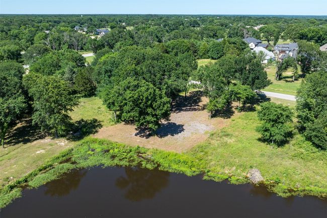 Aerial view of a nearby body of water and a heavily wooded area | Image 10