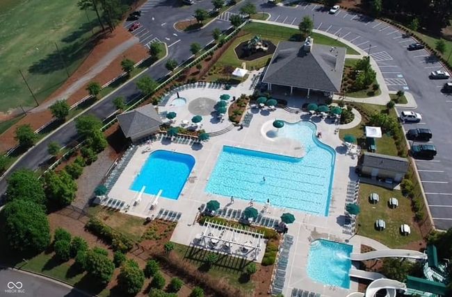aerial overview of the pool, Outdoor heated Junior Olympic PoolSplash Pad, Expansive Deck with lounge chairs, two slides and diving board | Image 124