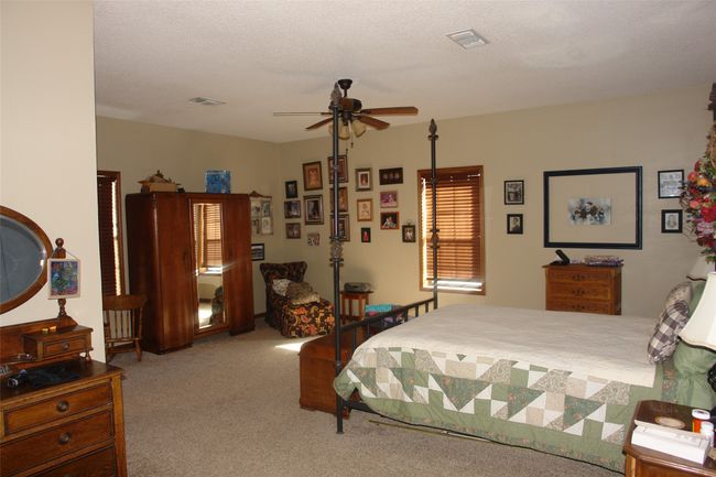 Bedroom featuring light carpet and a textured ceiling | Image 8