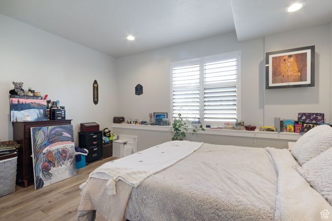 Bedroom with wood finished floors and recessed lighting | Image 26