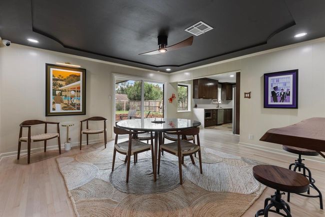 The modern dining room could easily fit a six person table and offers easy access to the patio and kitchen. This floor plan functions perfectly for everyday living or entertaining. | Image 5