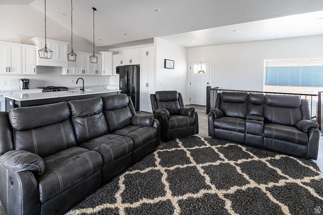 Living room featuring wood finished floors and high vaulted ceiling | Image 4