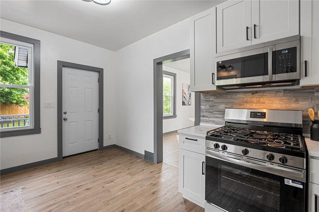 Gorgeous kitchen with easy walk out to a cozy covered porch—your new favorite spot to relax | Image 13