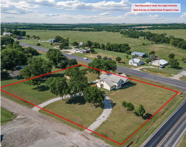 Aerial view of sparsely populated area featuring property parcel outlined | Image 40