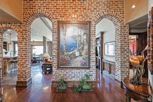 Hall with ornate columns, arched walkways, a towering ceiling, and hardwood / wood-style flooring | Image 26