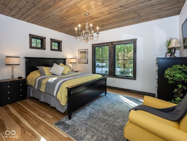 bedroom with a chandelier, wood finished floors, wooden ceiling, and baseboards | Image 26